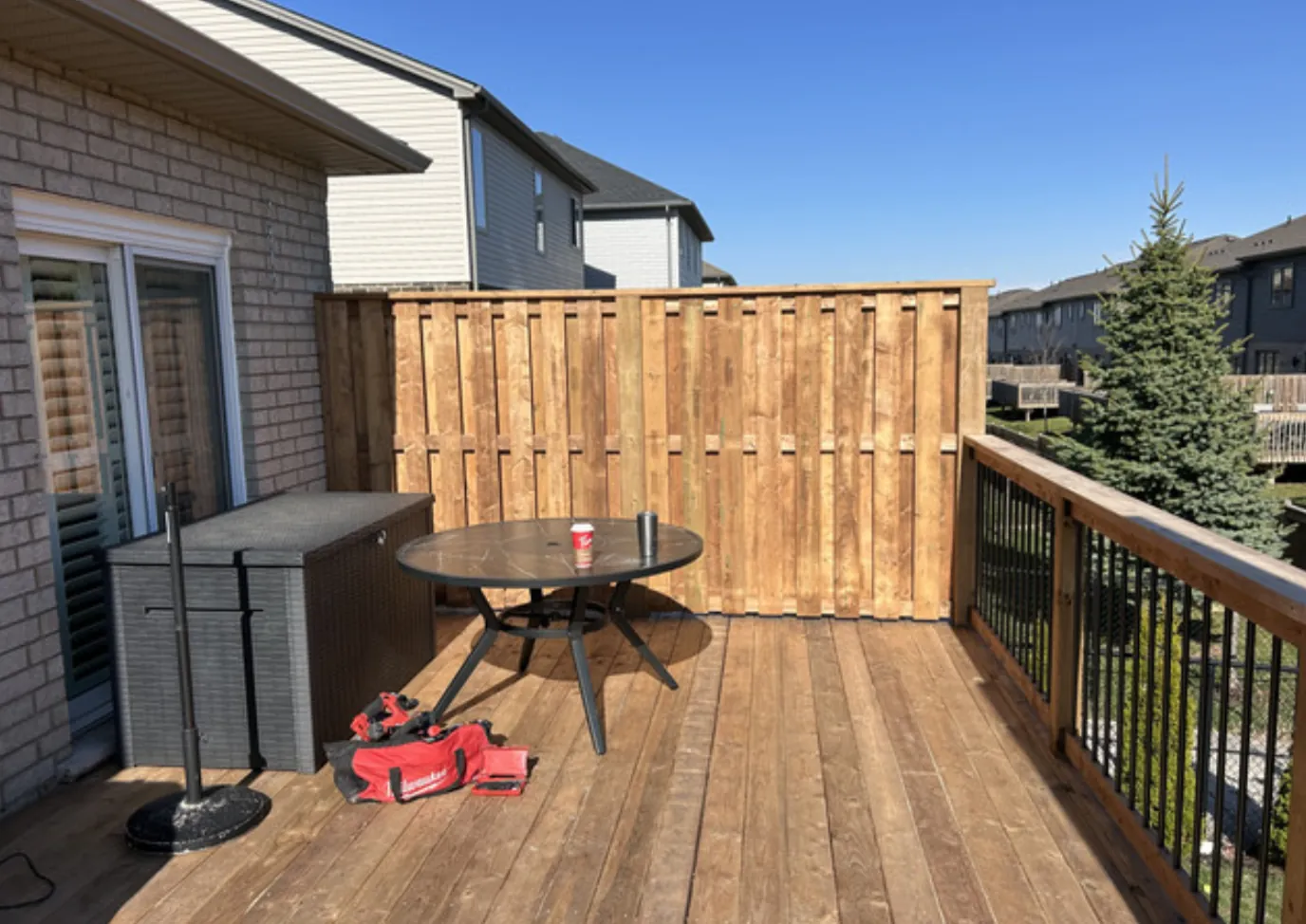 Ultimate Deck Revamp wide view of the main deck space with privacy wall and railing